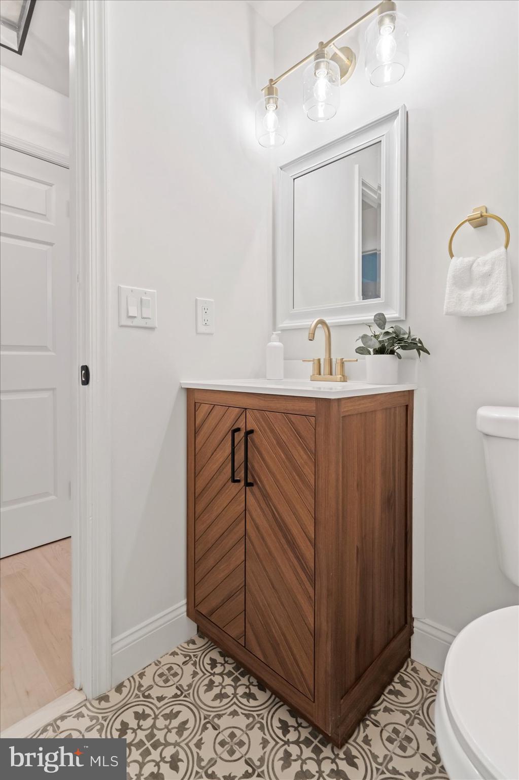 4566 Hickory Lane Mount Airy, MD 21771 - Photo 31 of 45 a bathroom with a sink a toilet and mirror