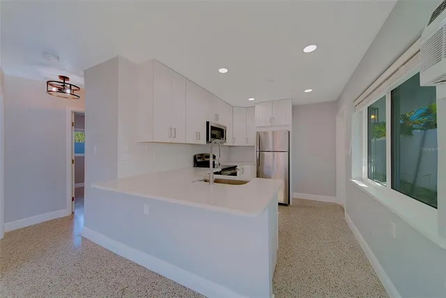 a kitchen with a sink and cabinets
