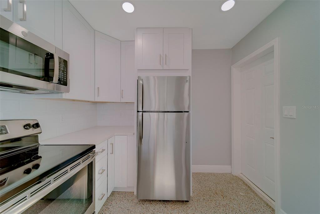 13248 4th Street East, Unit B Madeira Beach, FL 33708 - Photo 15 of 49 a kitchen with appliances and cabinets