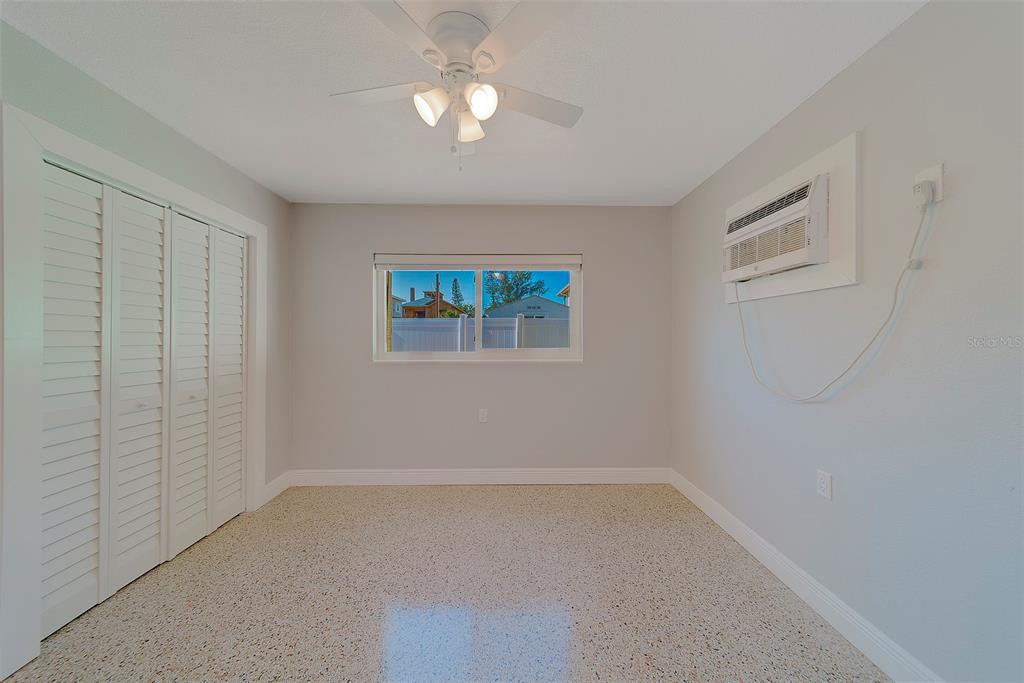 13248 4th Street East, Unit B Madeira Beach, FL 33708 - Photo 17 of 49 wooden floor in an empty room with a window