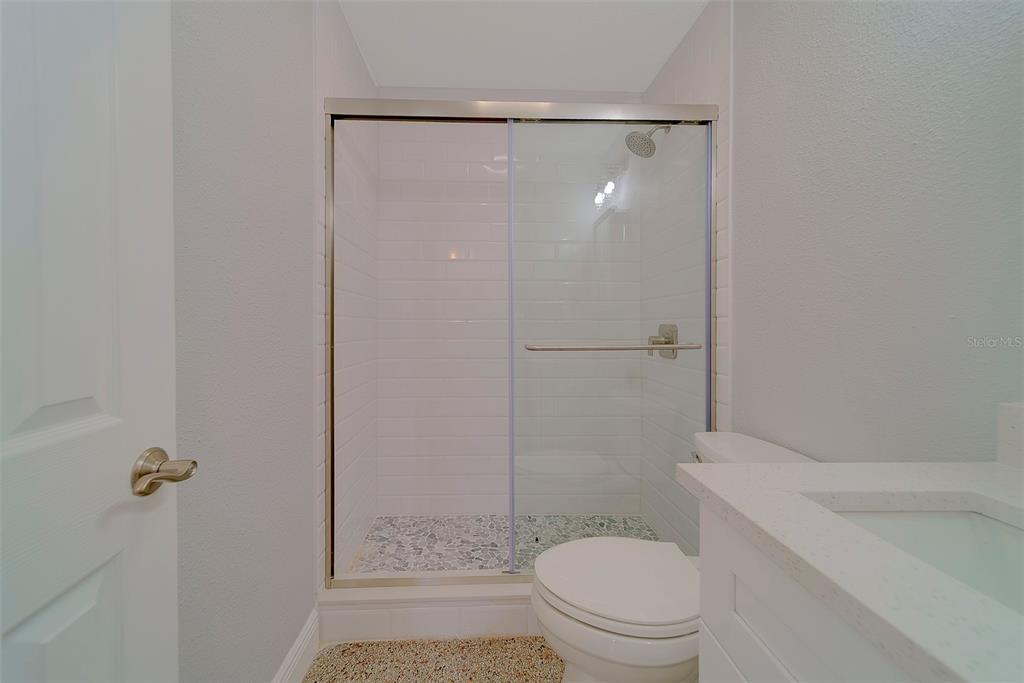 13248 4th Street East, Unit B Madeira Beach, FL 33708 - Photo 20 of 49 a bathroom with a shower a toilet and sink