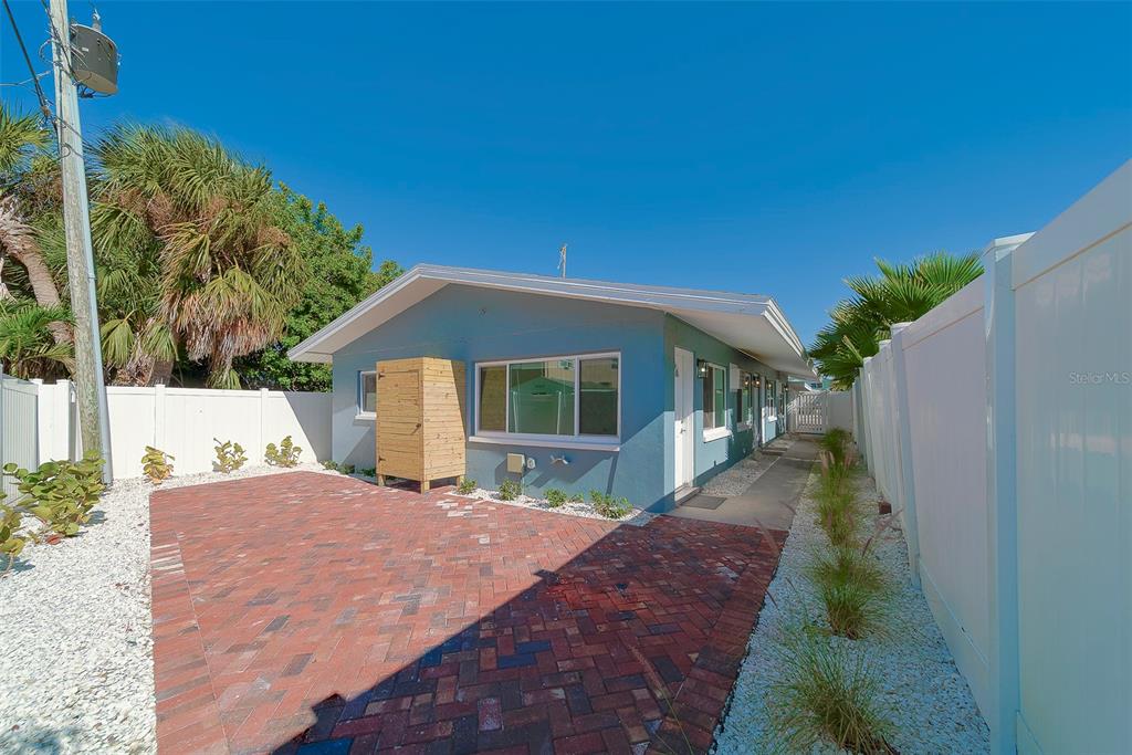 13248 4th Street East, Unit B Madeira Beach, FL 33708 - Photo 26 of 49 a front view of a house with a yard