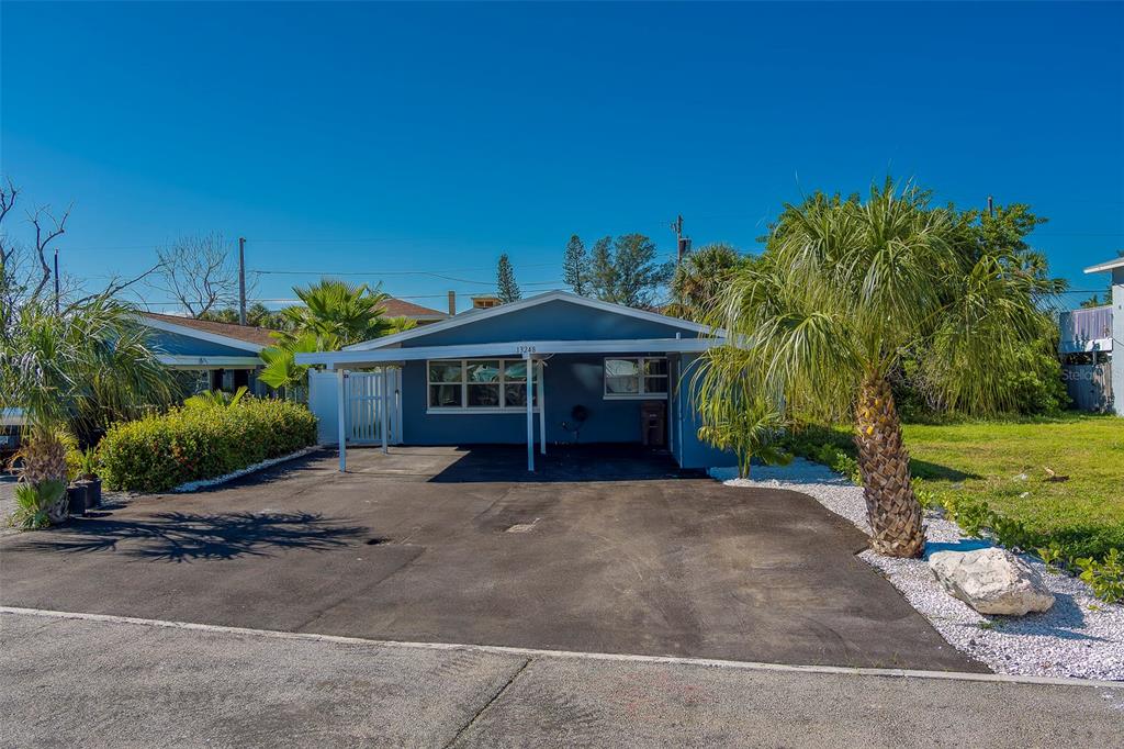 13248 4th Street East, Unit B Madeira Beach, FL 33708 - Photo 35 of 49 a front view of a house with a yard