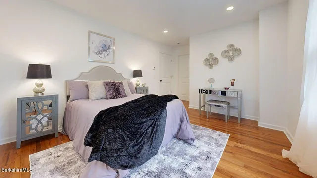 a bed room with a bed and a chair