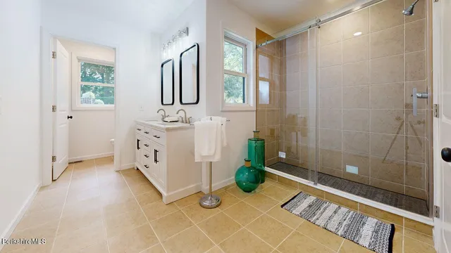 a bathroom with a double vanity sink and a mirror