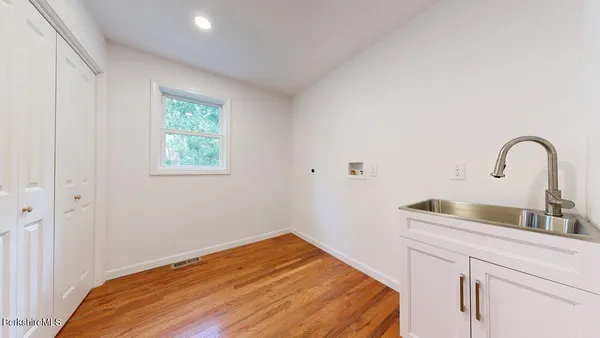 a bedroom with a bed and a sink