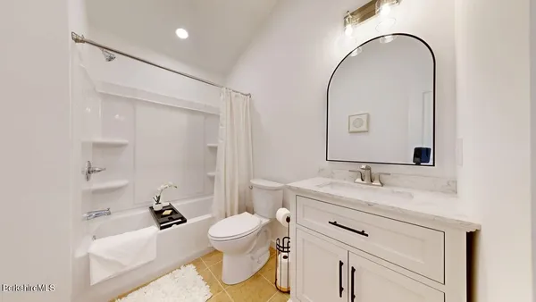 a bedroom with a bed and a table in it