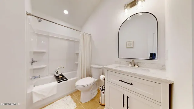 a bedroom with a bed and a table in it