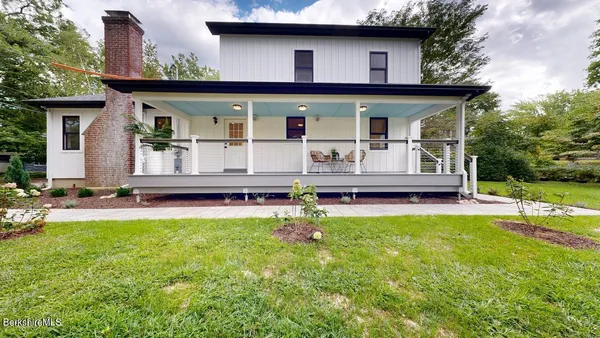 a view of a house with pool and wooden floor