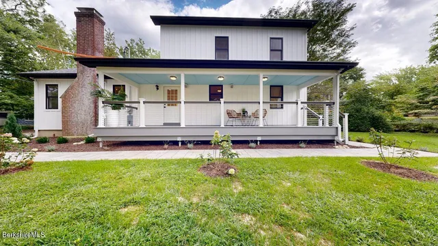 a view of a house with pool and wooden floor