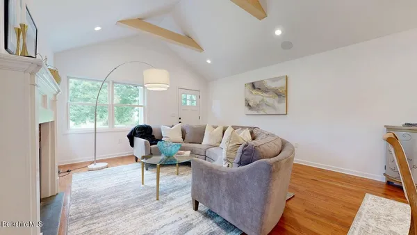 a living room with furniture and large windows