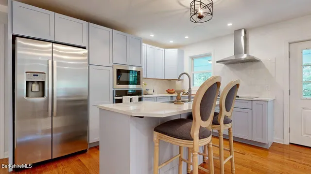 a kitchen with cabinets and stainless steel appliances