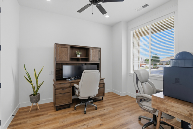 2278 Tawny Ridge Circle St. George, UT 84790 - Photo 32 of 61 Bright room featuring a large window with blinds, wood-finish flooring, a ceiling fan, recessed lighting, and white baseboards.