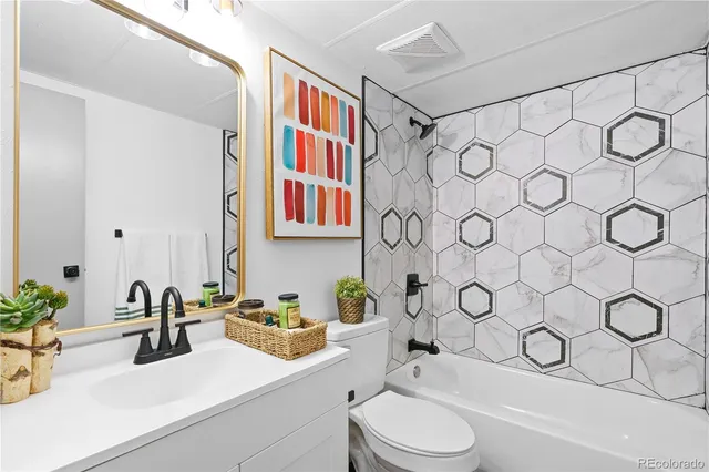 a bathroom with a sink a toilet and shower curtain