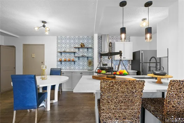 a living room with furniture a dining table and a chandelier