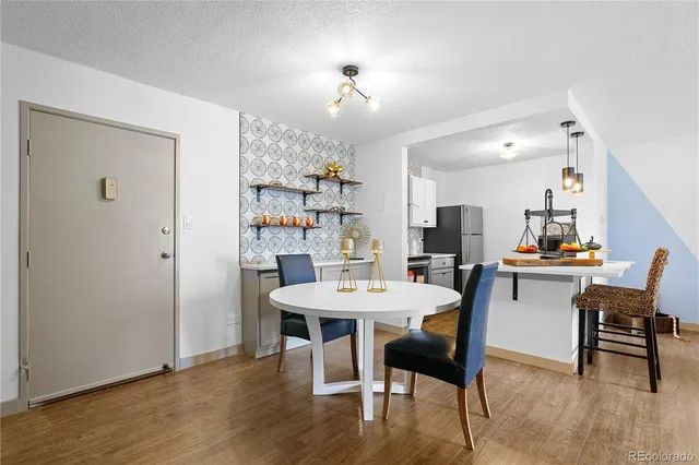 a view of a dining room with furniture and wooden floor