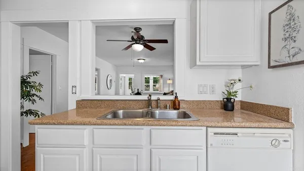 a kitchen with white cabinets and a sink