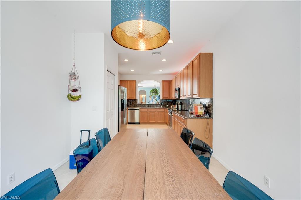 5738 Lago Villaggio Way Naples, FL 34104 - Photo 12 of 28 a view of a kitchen with wooden floor and a sink