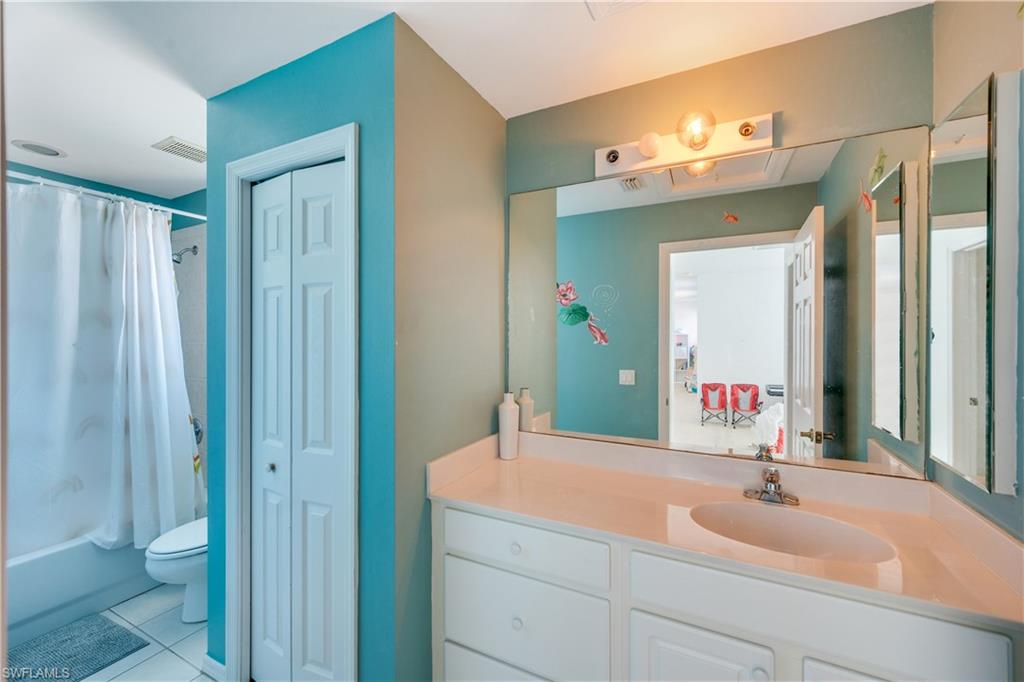 5738 Lago Villaggio Way Naples, FL 34104 - Photo 15 of 28 a bathroom with a sink and a mirror