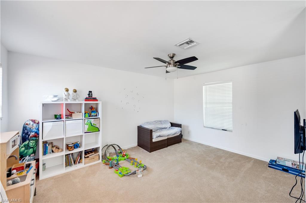 5738 Lago Villaggio Way Naples, FL 34104 - Photo 16 of 28 a room with toys and a couch