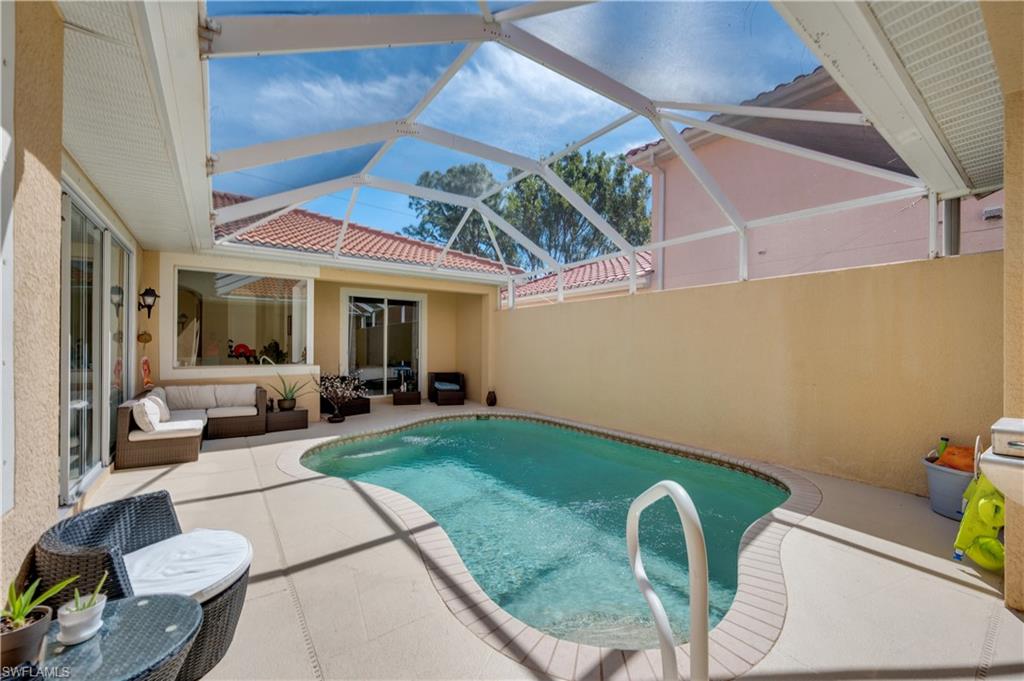 5738 Lago Villaggio Way Naples, FL 34104 - Photo 18 of 28 a view of swimming pool with outdoor seating