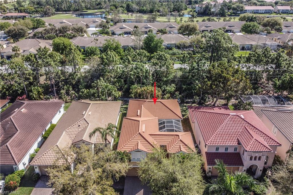 5738 Lago Villaggio Way Naples, FL 34104 - Photo 21 of 28 an aerial view of a house with a yard and lake view