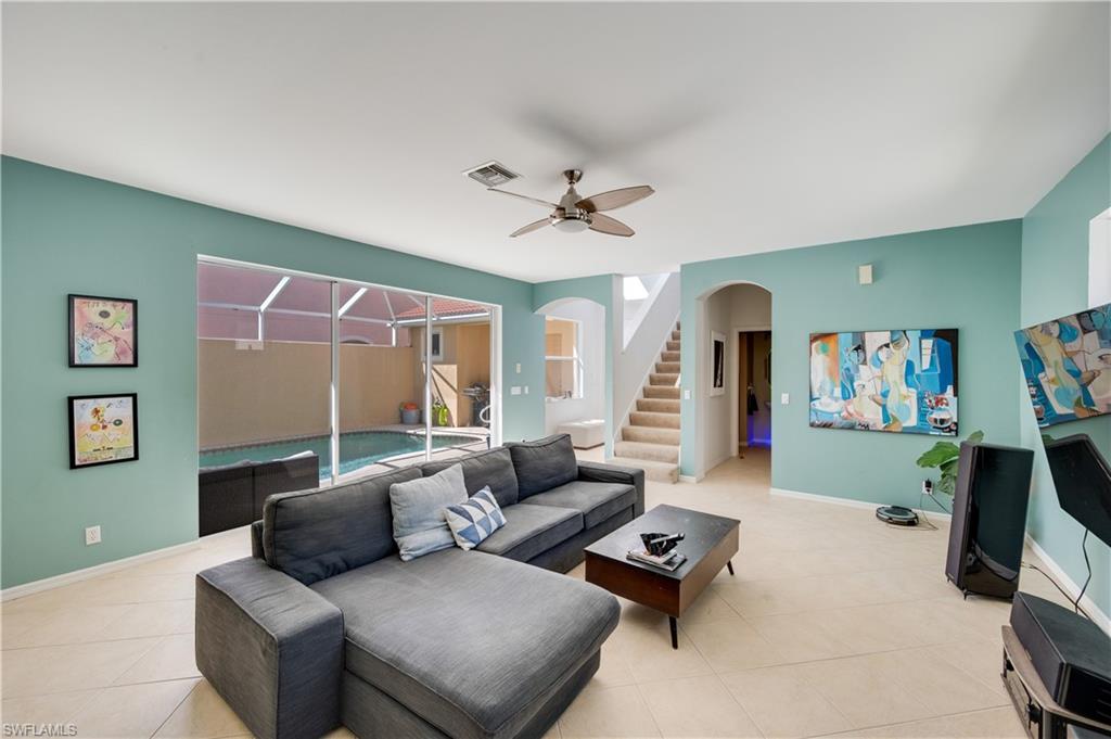 5738 Lago Villaggio Way Naples, FL 34104 - Photo 3 of 28 a living room with furniture and a large window