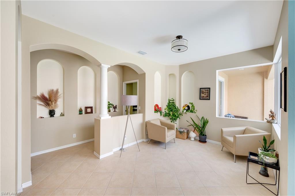 5738 Lago Villaggio Way Naples, FL 34104 - Photo 5 of 28 a view of livingroom with furniture and wooden floor
