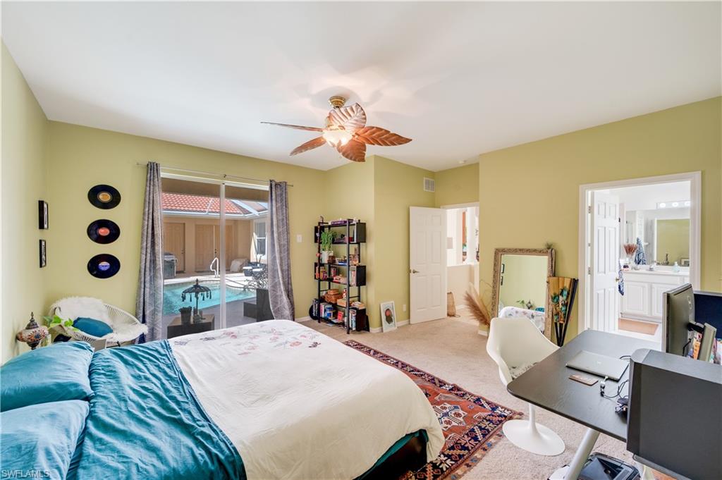 5738 Lago Villaggio Way Naples, FL 34104 - Photo 7 of 28 a bed room with bed and a chandelier