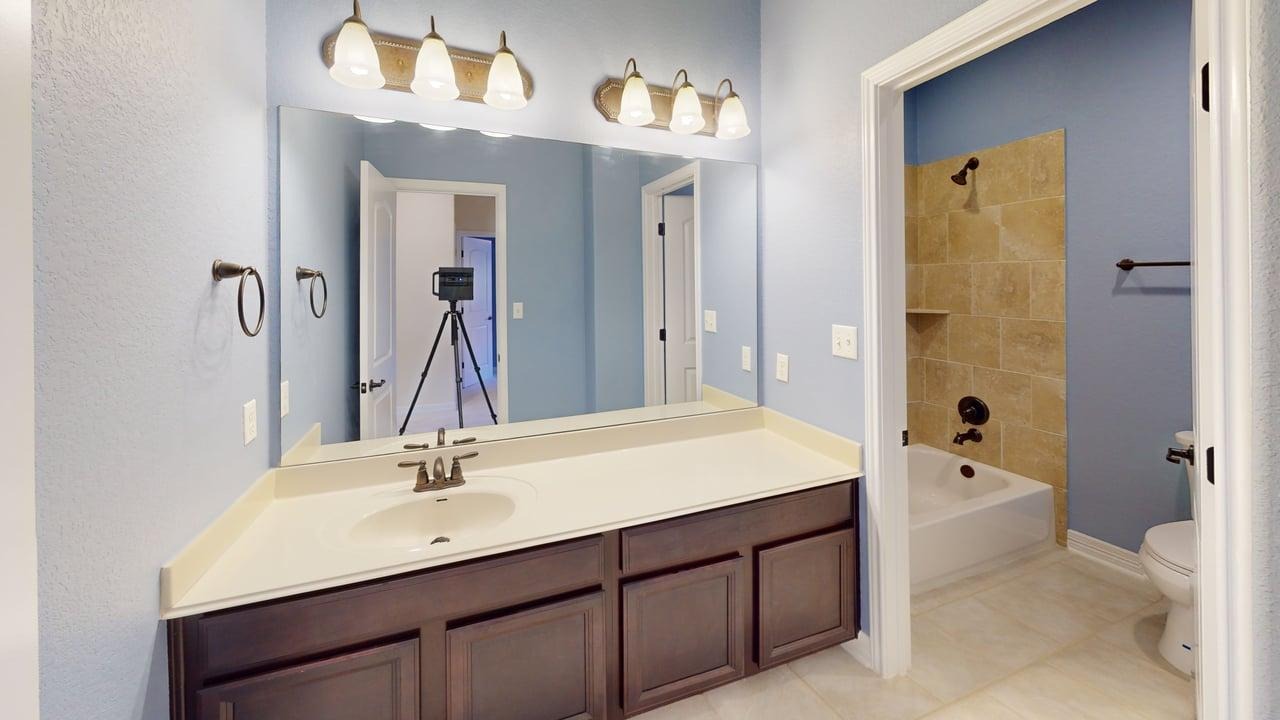 12004 Terraza Circle, Unit TH32 Austin, TX 78726 - Photo 11 of 25 a bathroom with a sink double vanity granite tub shower and a mirror