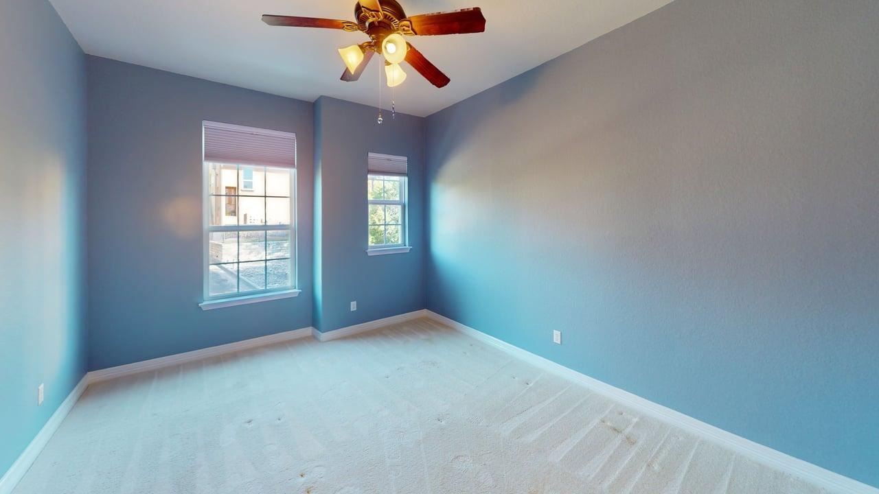 12004 Terraza Circle, Unit TH32 Austin, TX 78726 - Photo 12 of 25 an empty room with windows and fan