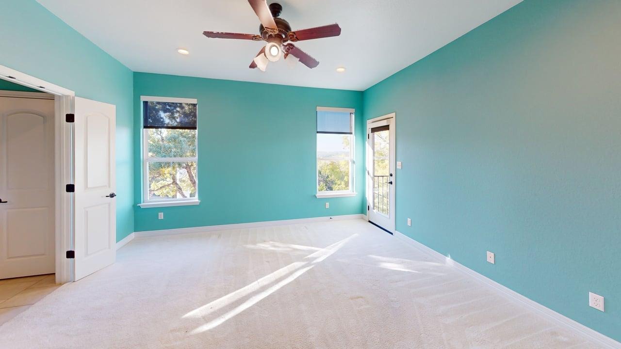 12004 Terraza Circle, Unit TH32 Austin, TX 78726 - Photo 17 of 25 a bedroom with windows and a ceiling fan