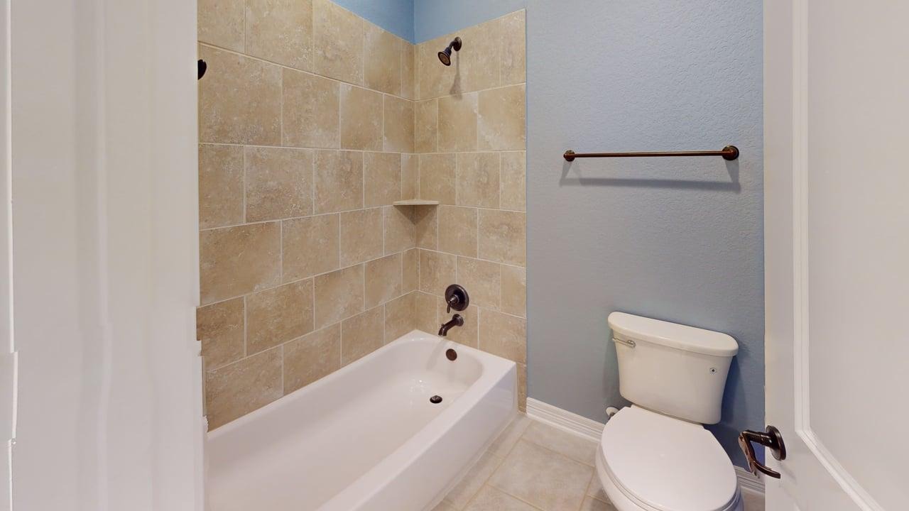 12004 Terraza Circle, Unit TH32 Austin, TX 78726 - Photo 9 of 25 a bathroom with a toilet bathtub and shower