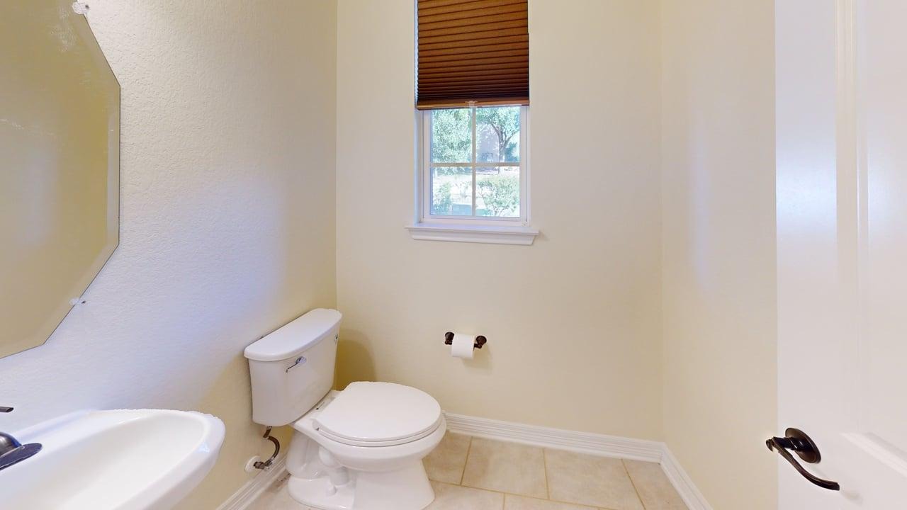 12004 Terraza Circle, Unit TH32 Austin, TX 78726 - Photo 10 of 25 a bathroom with a toilet and a sink