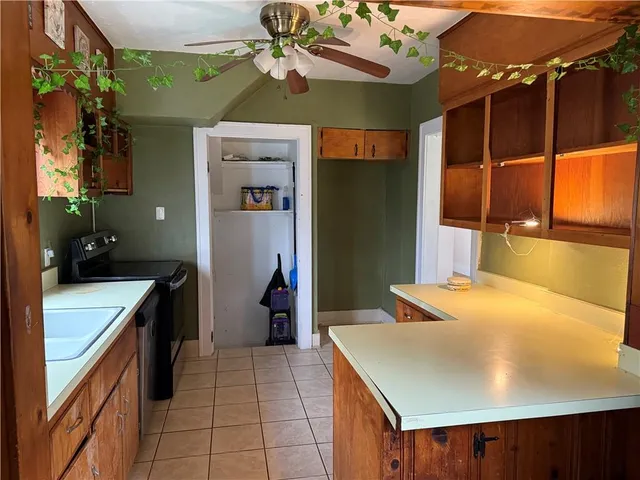 a kitchen with a sink a counter top space and cabinets
