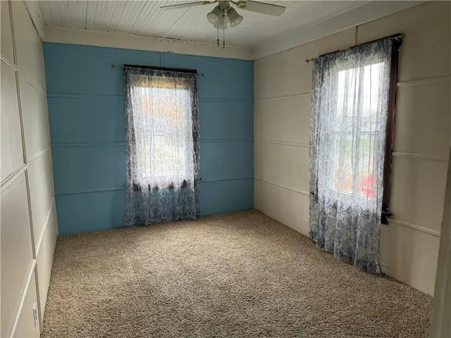 an empty room with windows and entrance