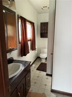 a bathroom with a sink a toilet and mirror