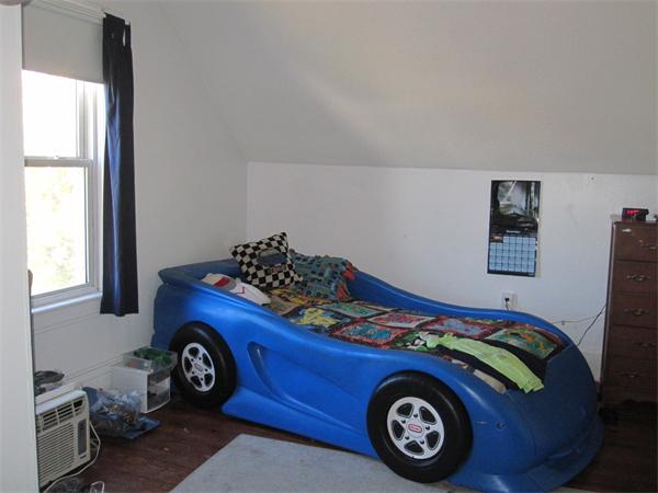 35 Lenox Street Springfield, MA 01108 - Photo 8 of 24 a bed with a bed and a car in it