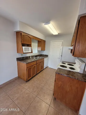 a kitchen with a stove a sink and a microwave