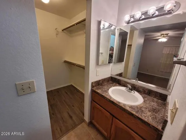 a bathroom with a granite countertop sink and a mirror