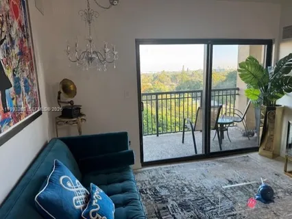 a living room with furniture and a floor to ceiling window