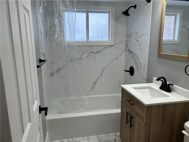 a bathroom with a sink a mirror and a bathtub