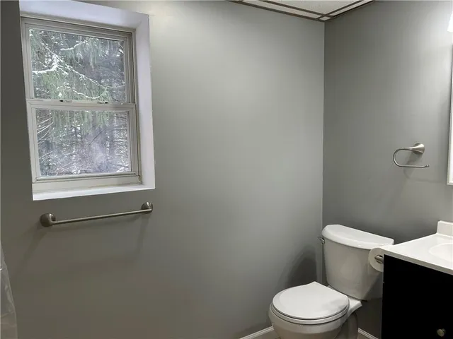 a white toilet sitting next to a bathroom sink