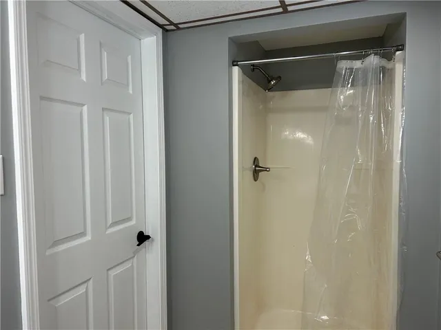 a bathroom with a glass shower door
