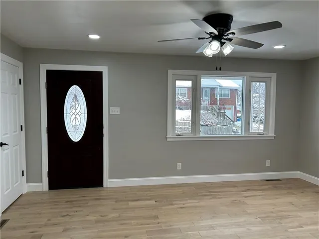 a view of a livingroom with furniture wooden floor and a window