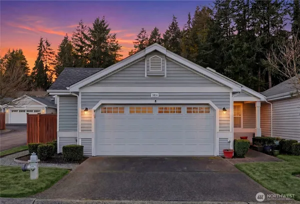 a front view of house with garage and yard