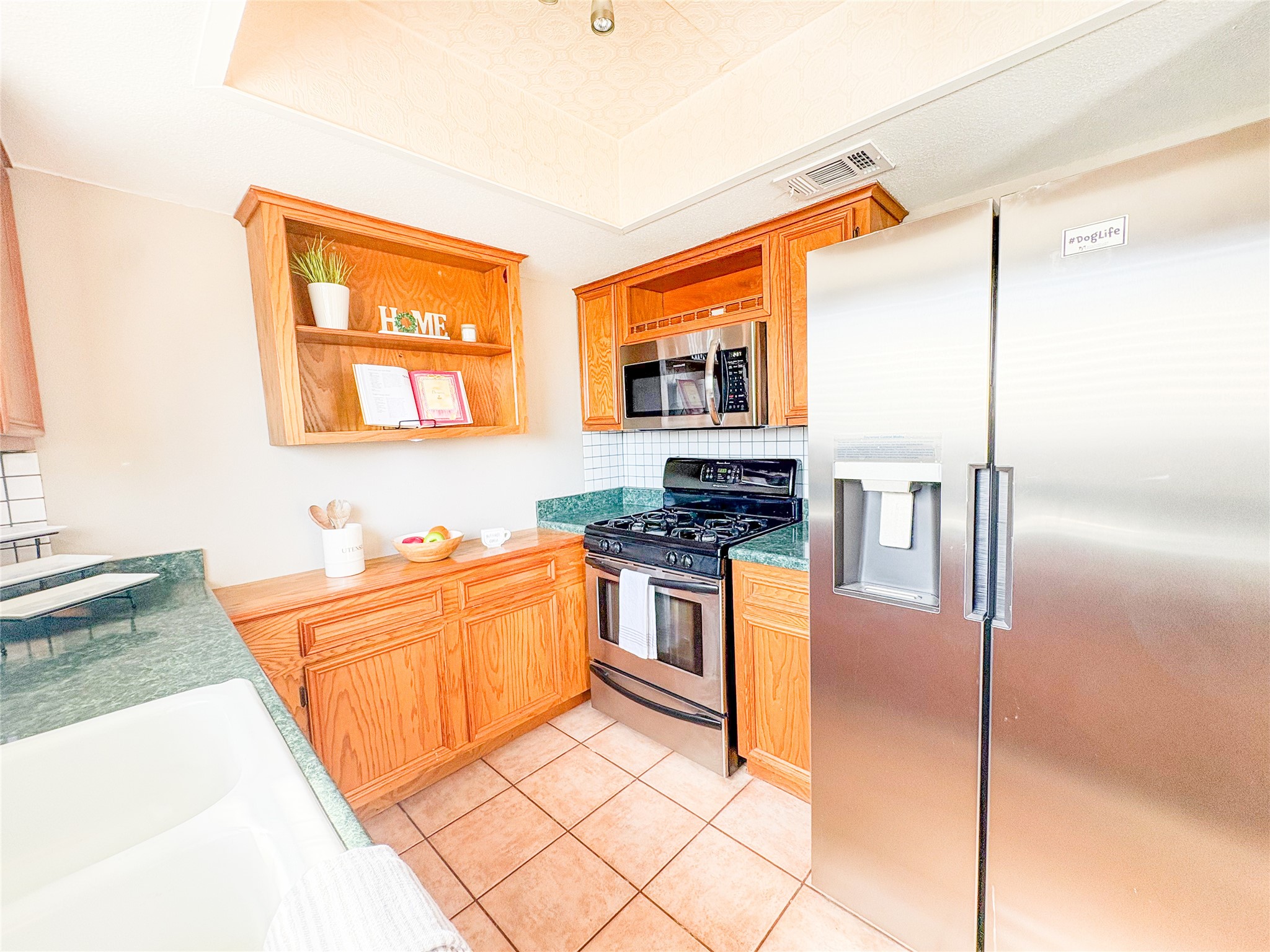 4135 Young Street Pasadena, TX 77504 - Photo 12 of 29 a kitchen with stainless steel appliances granite countertop a refrigerator and a stove top oven