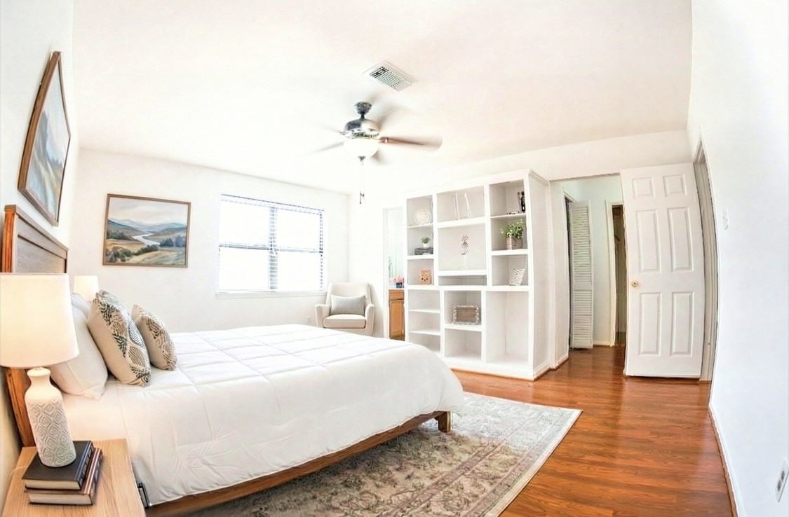 4135 Young Street Pasadena, TX 77504 - Photo 15 of 29 a bedroom with a large bed and a chandelier