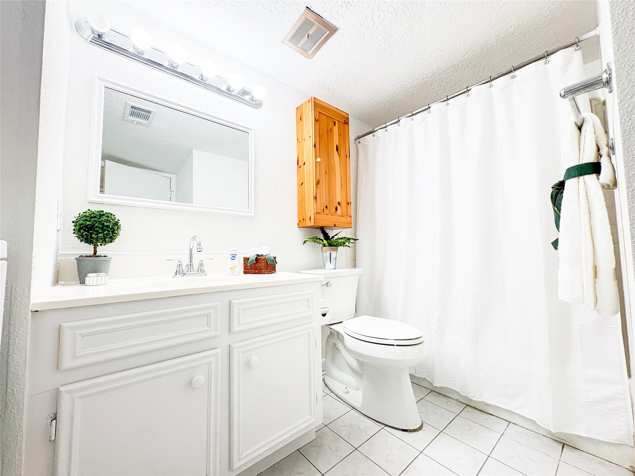 4135 Young Street Pasadena, TX 77504 - Photo 6 of 29 a bathroom with a sink a toilet and a mirror