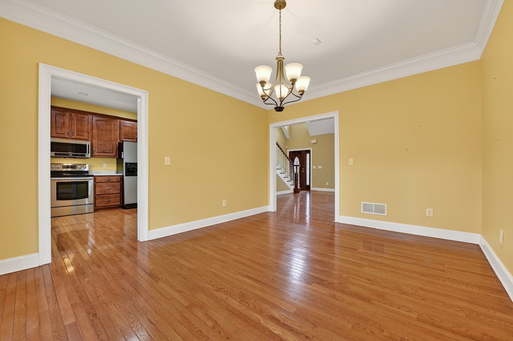 220 Oak Rdg Lane Ellijay, GA 30536 - Photo 12 of 36 a view of a livingroom with a chandelier wooden floor and a kitchen